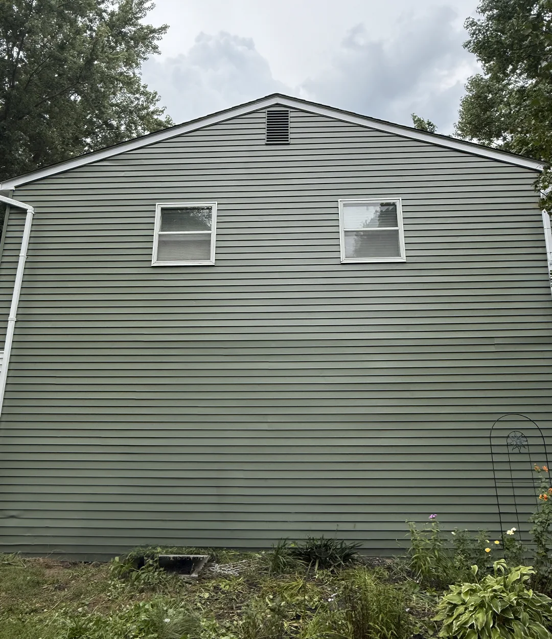 Home siding repainted sage green